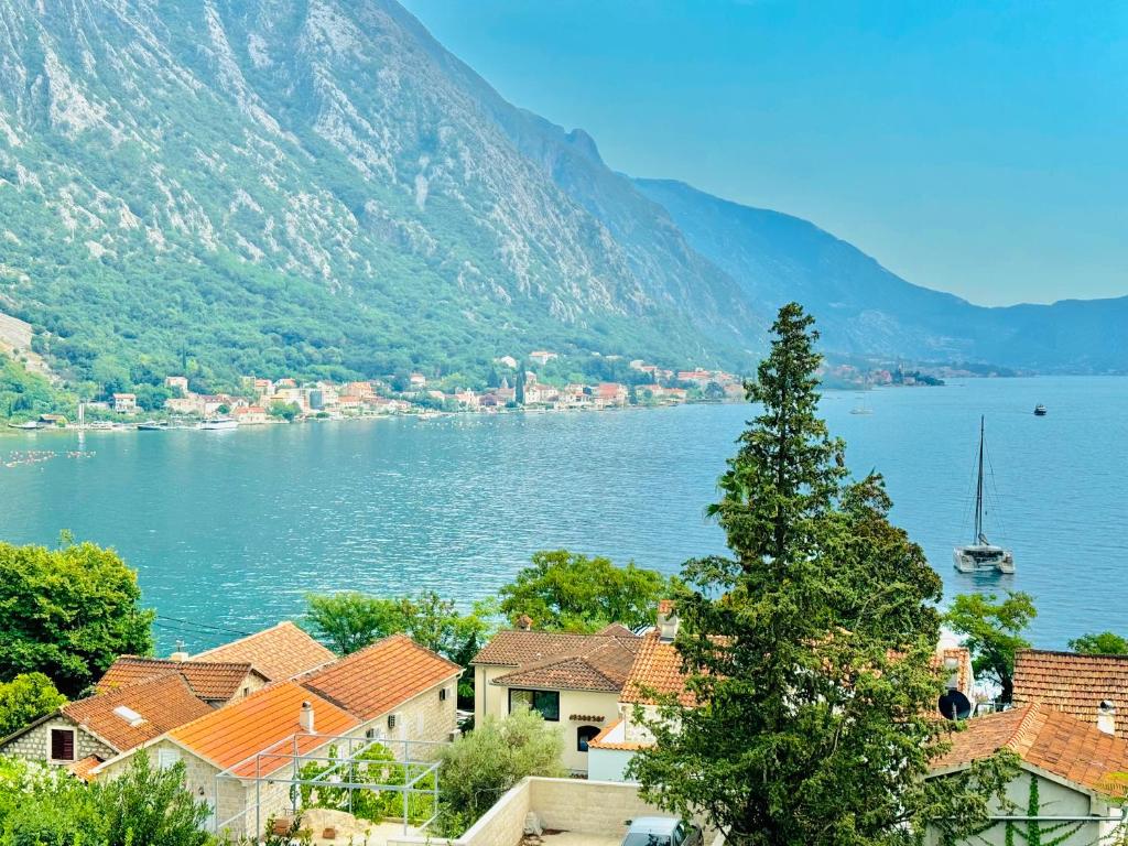 a view of a town with a lake and mountains at Orahovac sunny port in Kotor