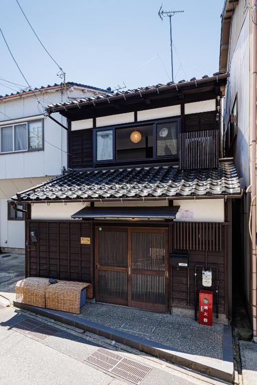 a building with a gate and a building at Sennichi House in Kanazawa