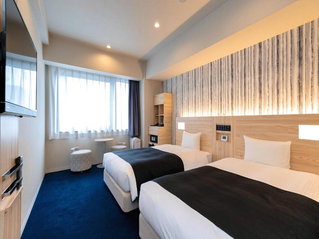 Postel nebo postele na pokoji v ubytování APA Hotel Kyoto Gojo Omiya