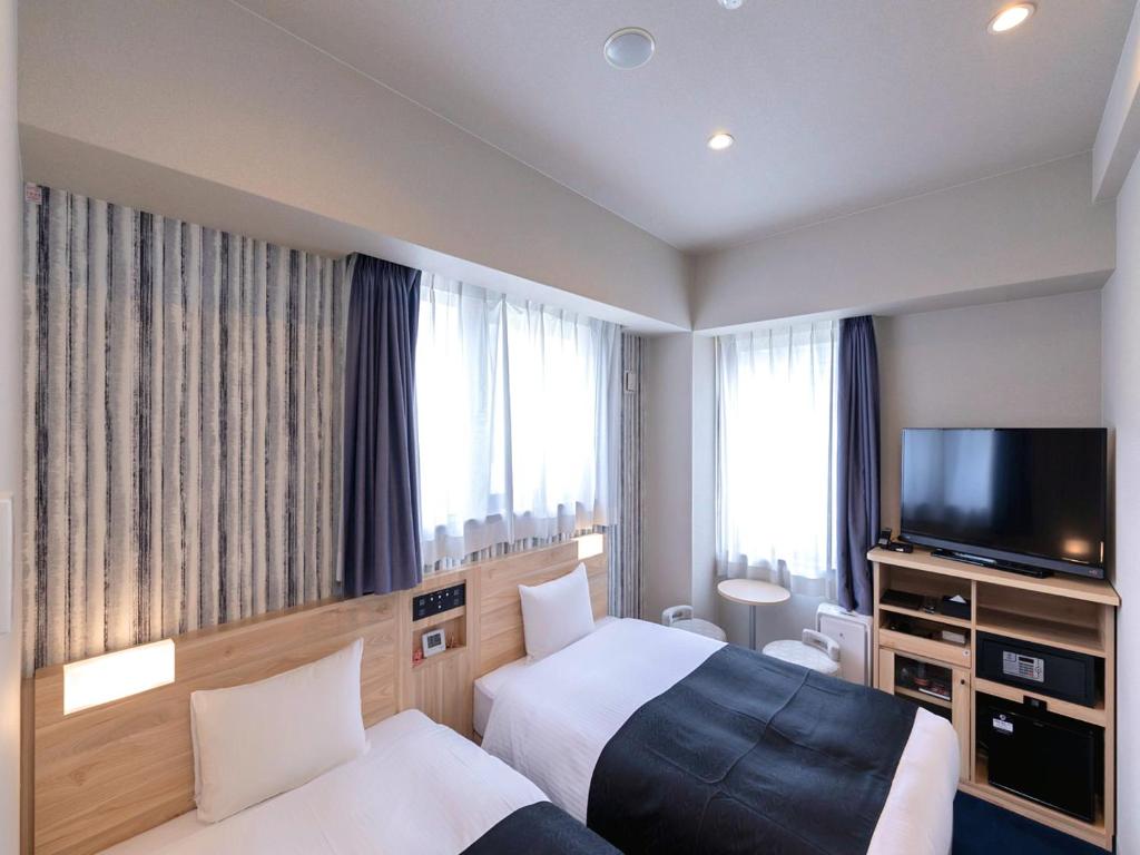 Postel nebo postele na pokoji v ubytování APA Hotel Kyoto Gojo Omiya