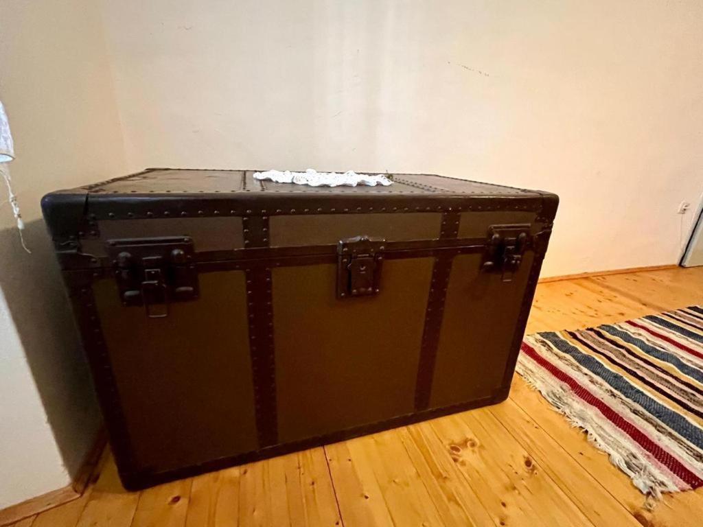 a black suitcase sitting on the floor in a room at Vila Klara rooms in Olib