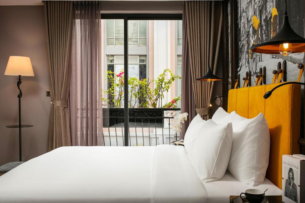 Postel nebo postele na pokoji v ubytování Hanoi Lion Boutique Hotel & Spa
