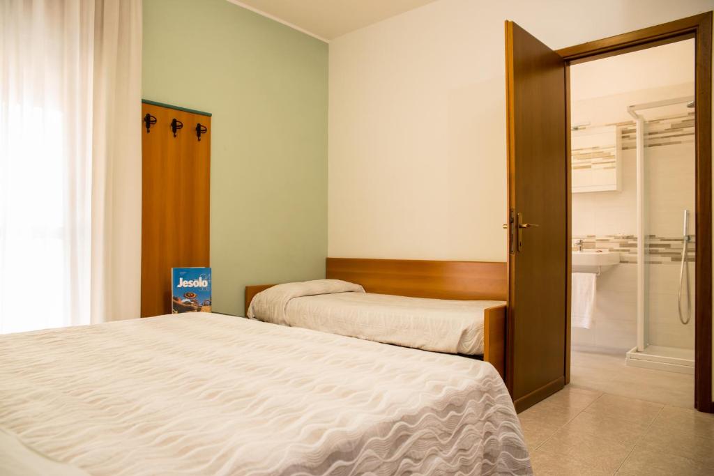 Postel nebo postele na pokoji v ubytování Albergo Ridente