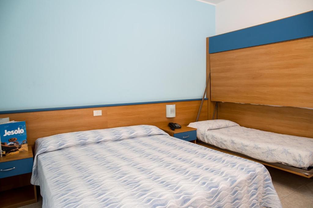 Postel nebo postele na pokoji v ubytování Albergo Ridente