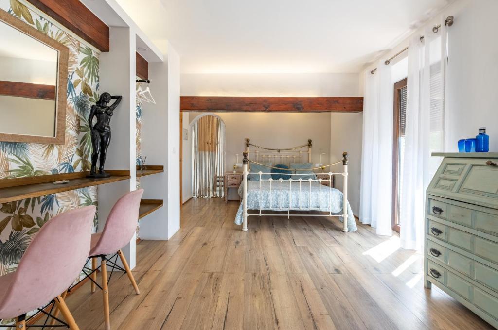 a bedroom with a bed and a wooden floor at La Tartana Hotel Boutique in La Herradura