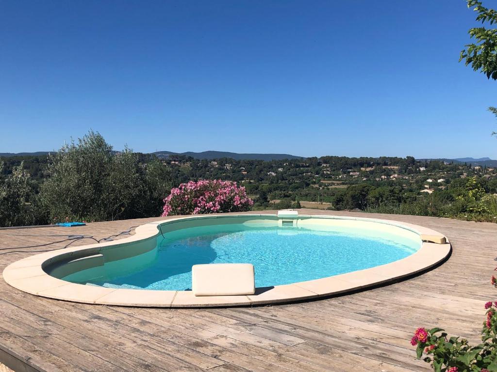 une grande piscine sur une terrasse en bois dans l'établissement Villa de Charme magnifique vue Panoramique et Piscine, à Lorgues