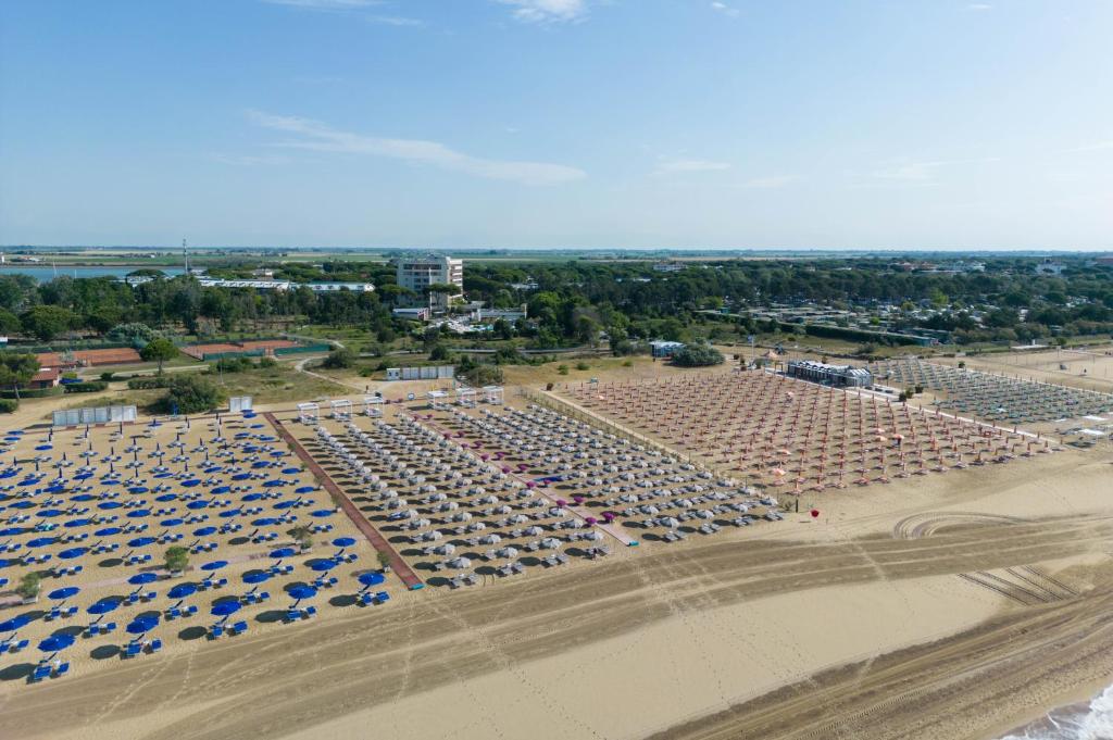 an aerial view of a large parking lot with umbrellas at Laguna Park Hotel 4Superior in Bibione