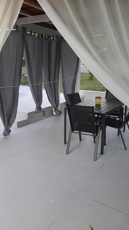a tent with a table and chairs under it at Apartmani Irena in Rtina