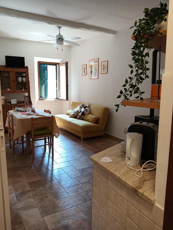 a living room with a couch and a table at La casina in Caprarola