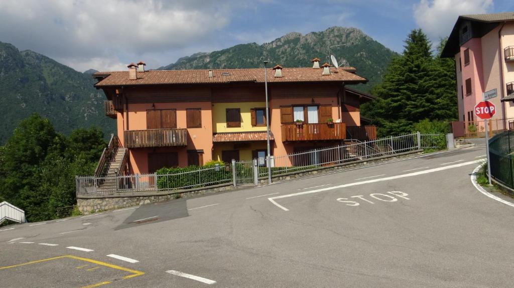 a house on the side of a road with a stop sign at Chalet Belvedere in Costa di Serina