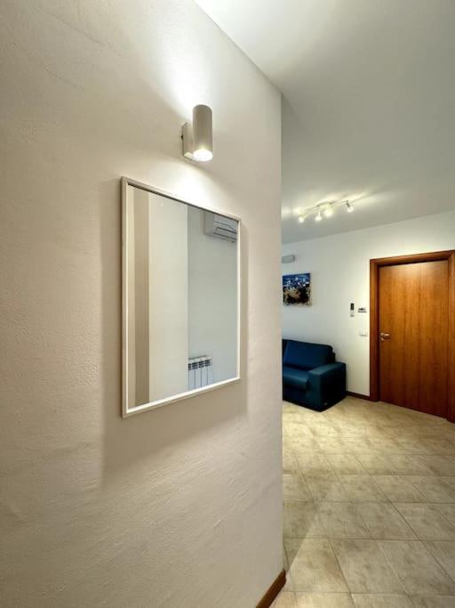 a living room with a mirror on the wall at Fontana Apartment in Perugia