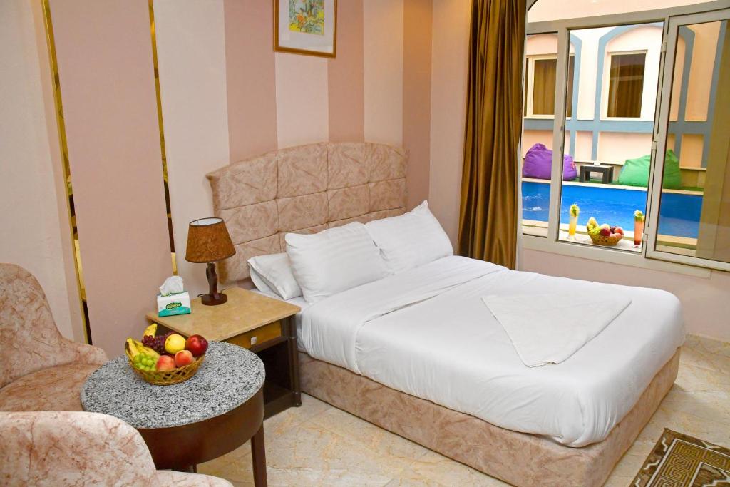 Postel nebo postele na pokoji v ubytování Nun Pyramids Hotel