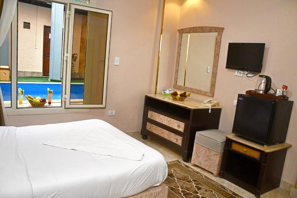 Postel nebo postele na pokoji v ubytování Nun Pyramids Hotel