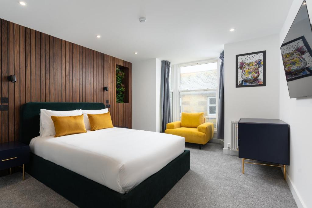 a bedroom with a bed and a yellow chair at Room 2 Hotel style Double bedroom in Marazion in Marazion