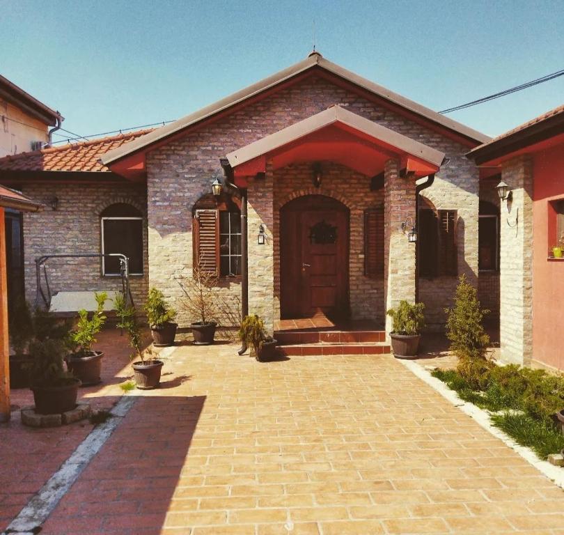 a brick house with a door and a brick driveway at Villa Royal in Belgrade