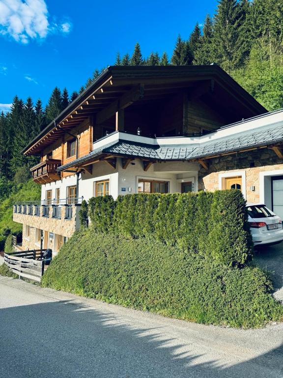 a house with a hedge in front of it at Mountainfloor in Grossarl