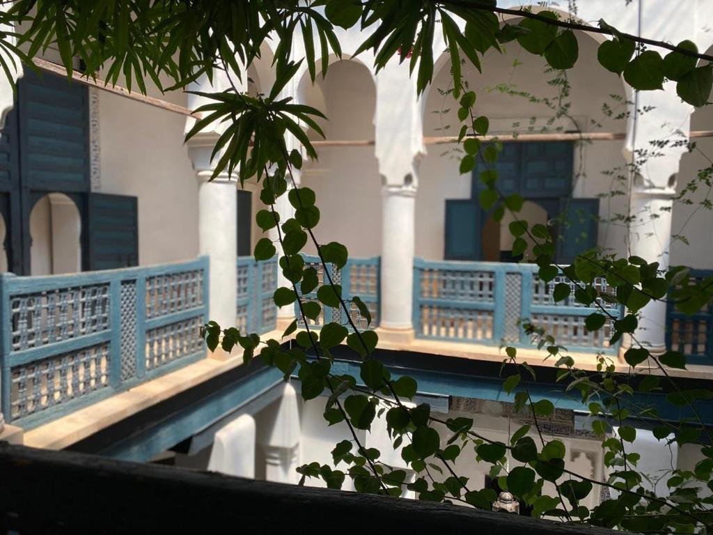 a view of a building with blue railing at Dar El Qadi in Marrakech