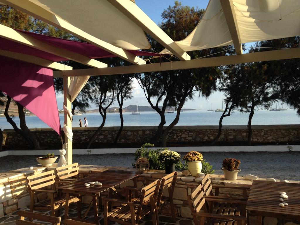 a group of tables and chairs under a tent at Almira Suites - Seafront - Naousa Paros in Naousa