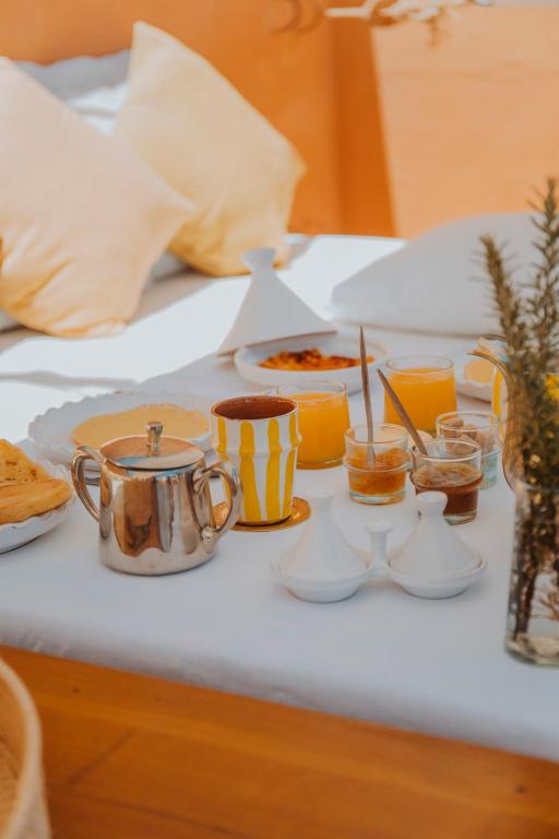 a table with a tray of food on a bed at Dar El Qadi in Marrakech