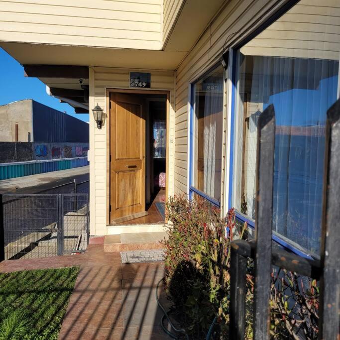 a house with a wooden door on a porch at Casa magallanica in Punta Arenas