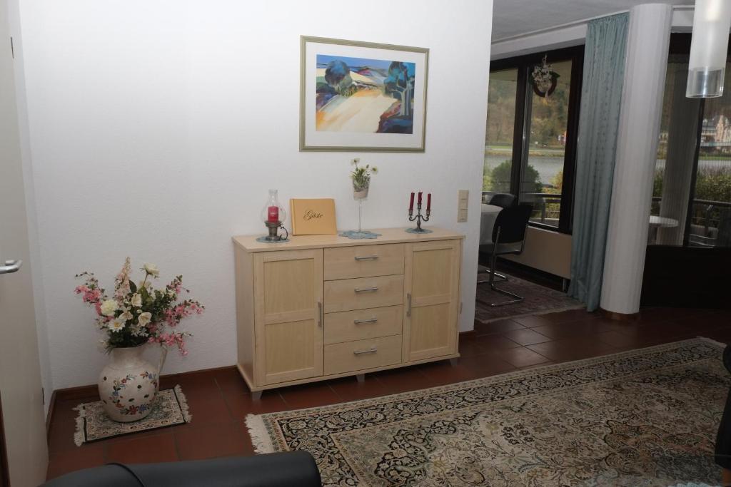 a living room with a dresser and a vase with candles at Fewo Steuer in Traben-Trarbach