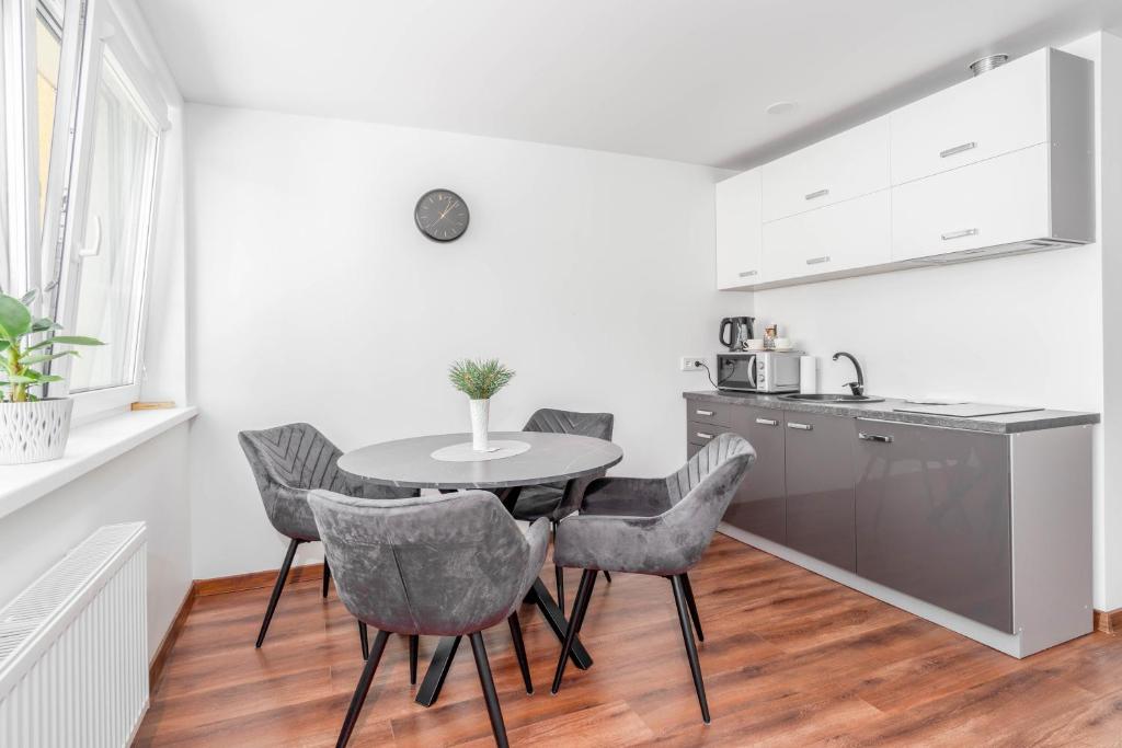 a kitchen with a table and chairs in a room at MALŪNO Calm Getaway SELF CHECK-IN in Klaipėda