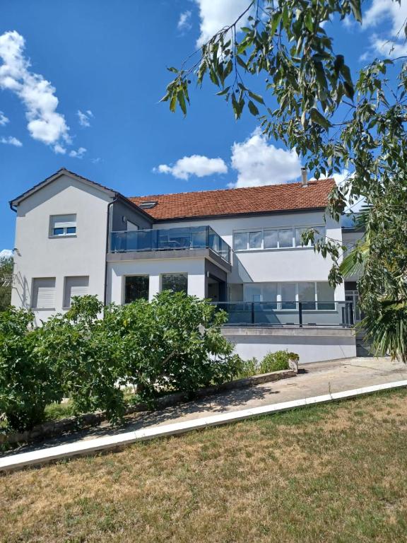a white house with a red roof at Villa Wild Rose in Imotski