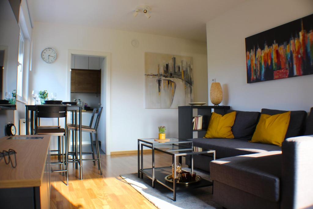 a living room with a couch and a table at Apartman Mali Muk, self check- in in Karlovac