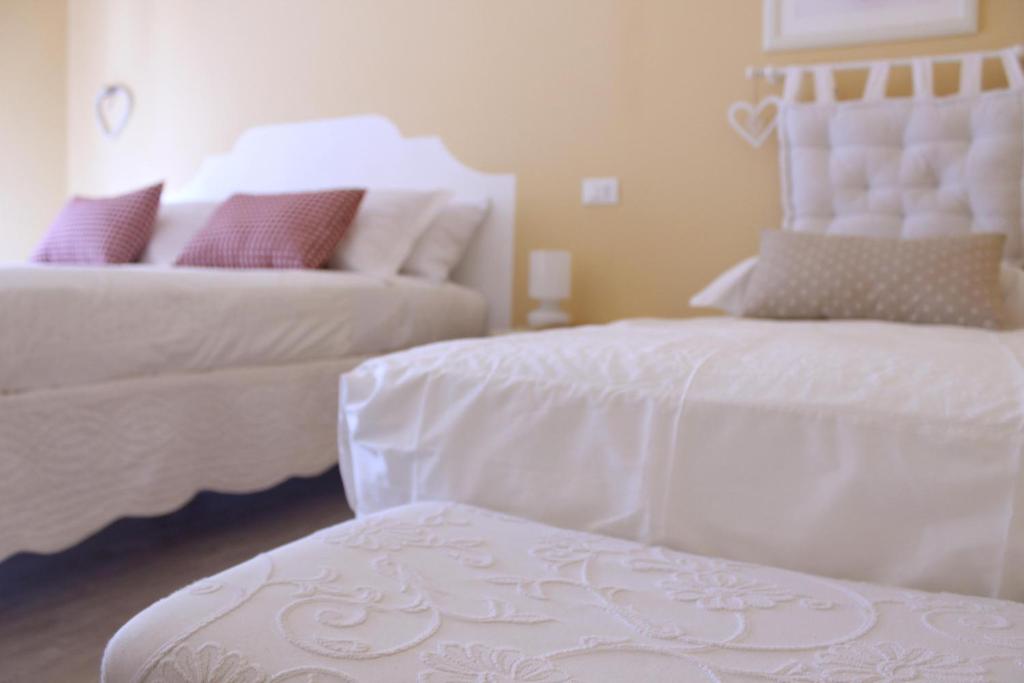 Posteľ alebo postele v izbe v ubytovaní B&B Nannalia
