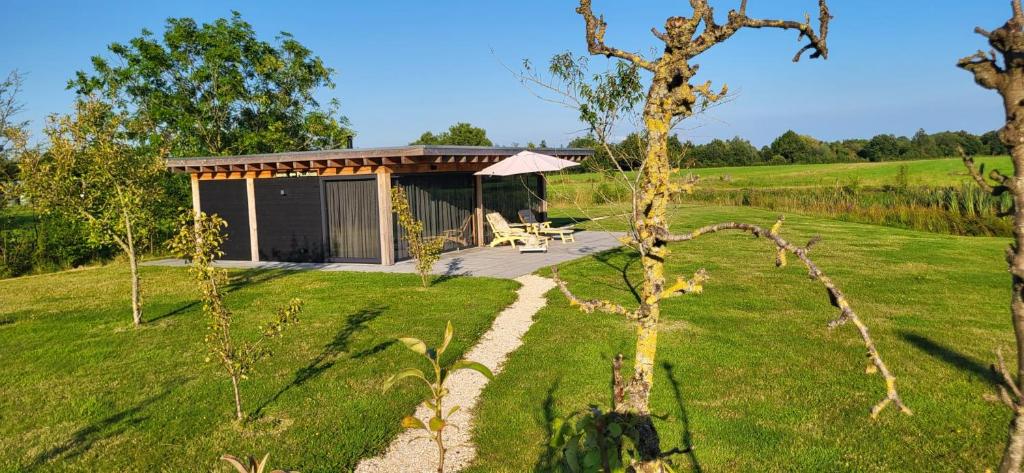 a cabin in the middle of a field at The Poolhouse in Buitenpost
