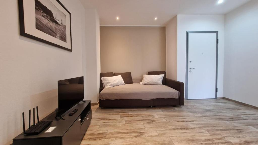 a bedroom with a bed and a television in it at Casa Lina Tirano in Tirano
