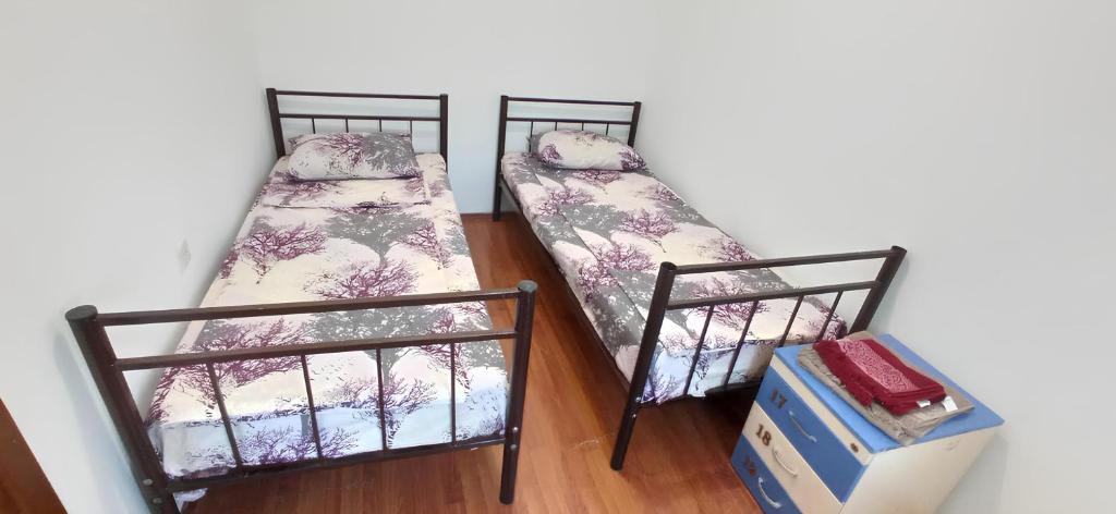two bunk beds in a room with a box at Double Gates Apartment in Baku