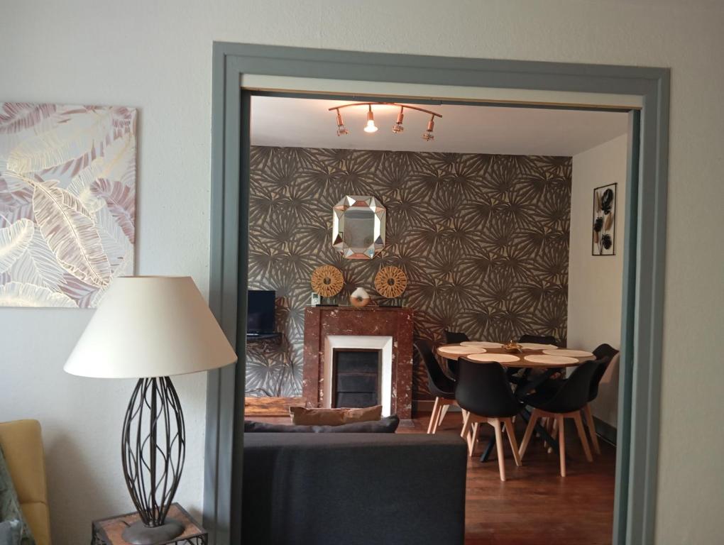 a dining room with a table and a mirror at Appartement hyper centre 3 Lorient in Lorient