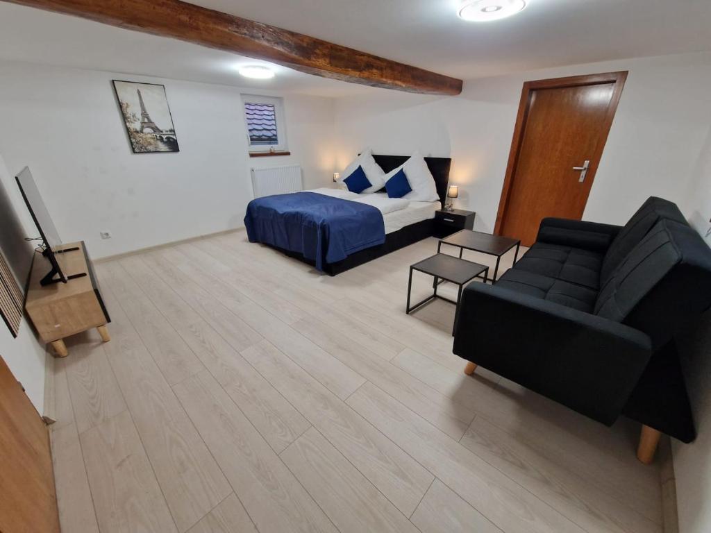 a living room with a bed and a couch at Laubach Apartments in Laubach