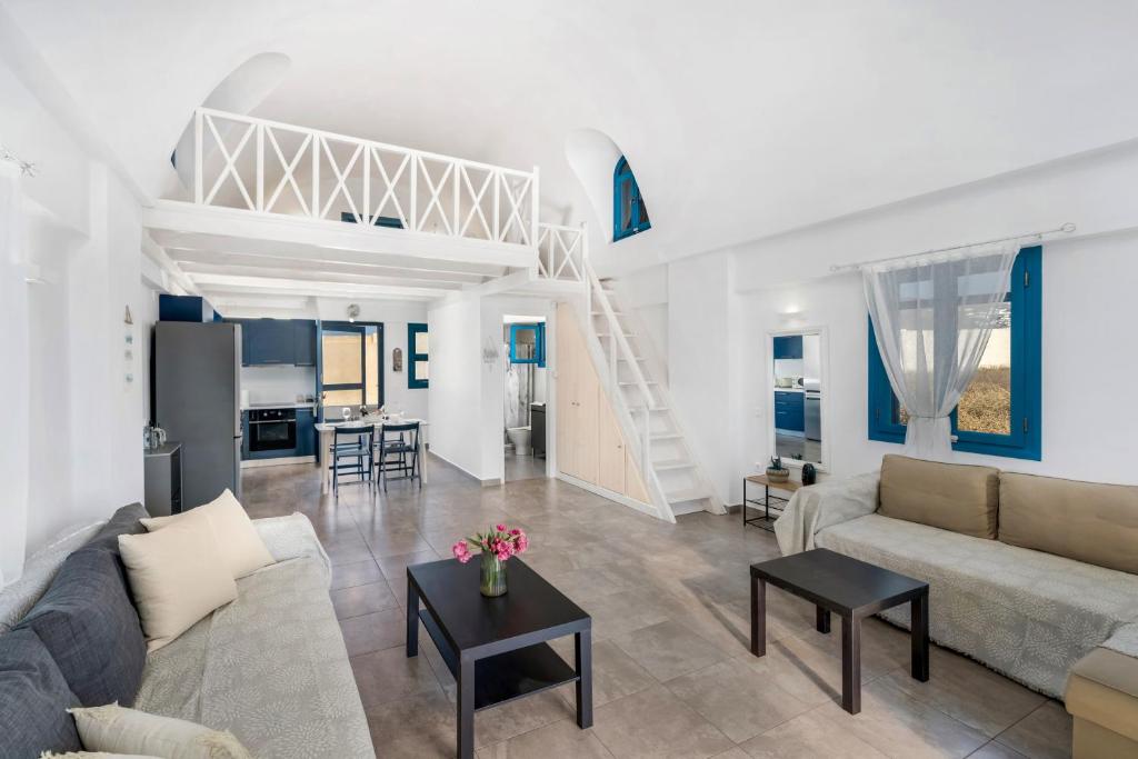a living room with a couch and a table at Electra Residence in Oia