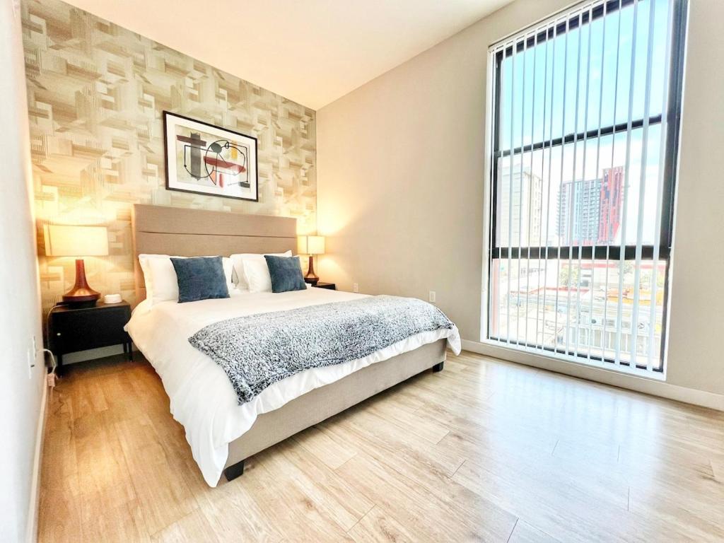 Un dormitorio con una cama y una ventana grande. en Downtown San Diego Getaway, en San Diego