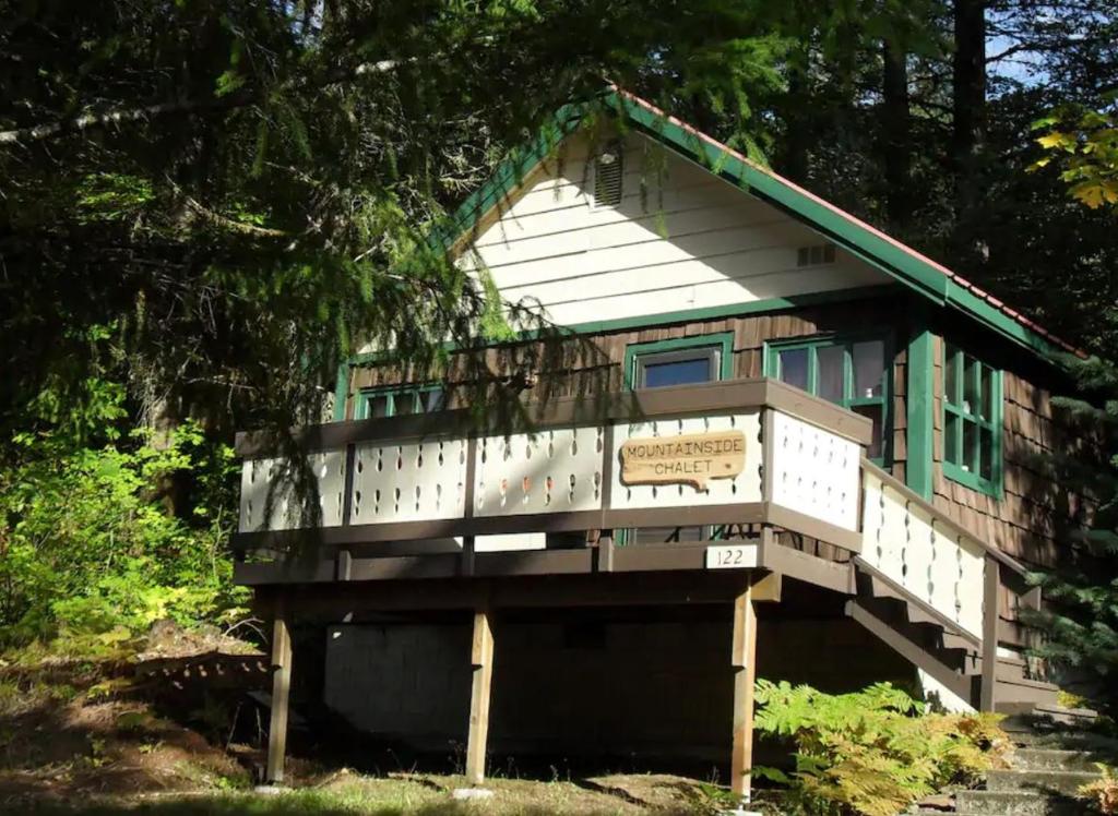 a house with a balcony on the side of it at Mountain Side Chalet in Packwood