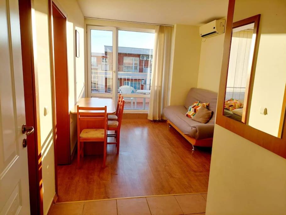 a living room with a table and a couch at Nessebar Fort Club apartment 363 in Sunny Beach