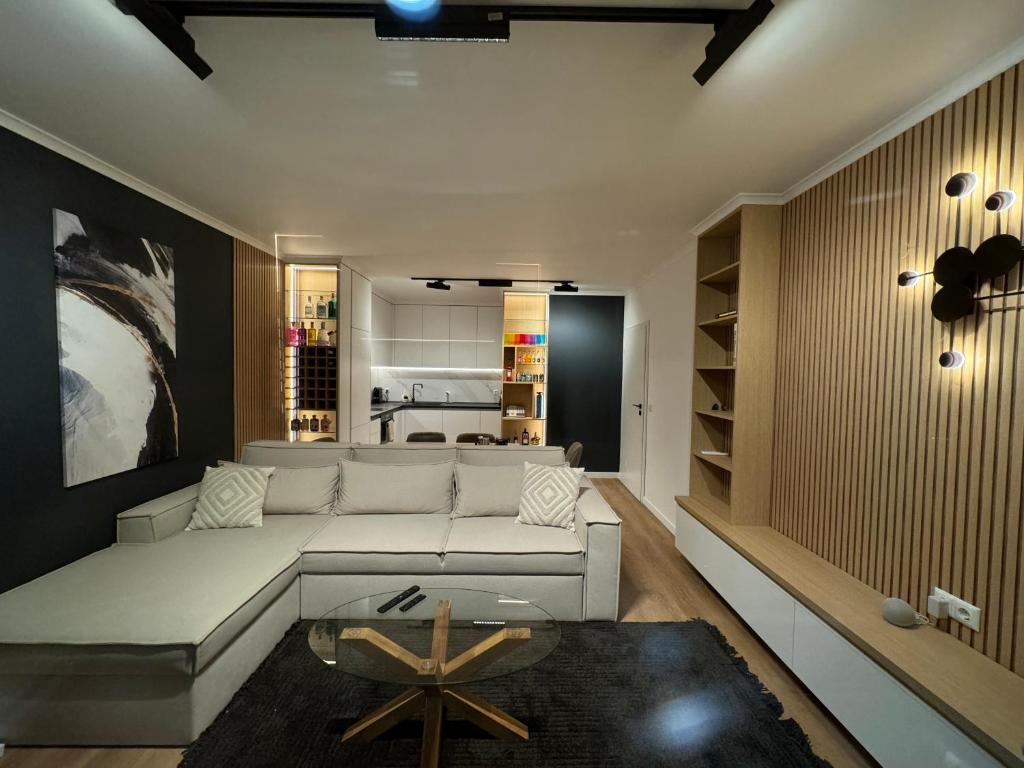 a living room with a white couch and a table at Seaview Smart Home 2 in Varna City