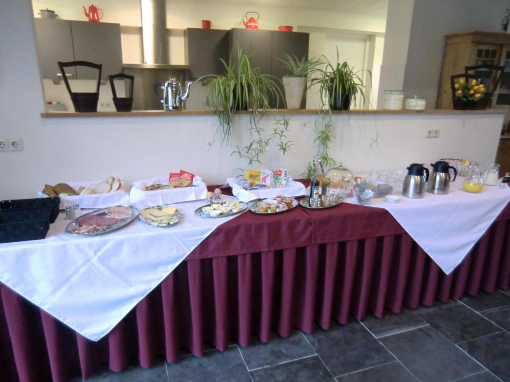 a table with plates of food on it at Horsetellerie Rheezerveen in Hardenberg