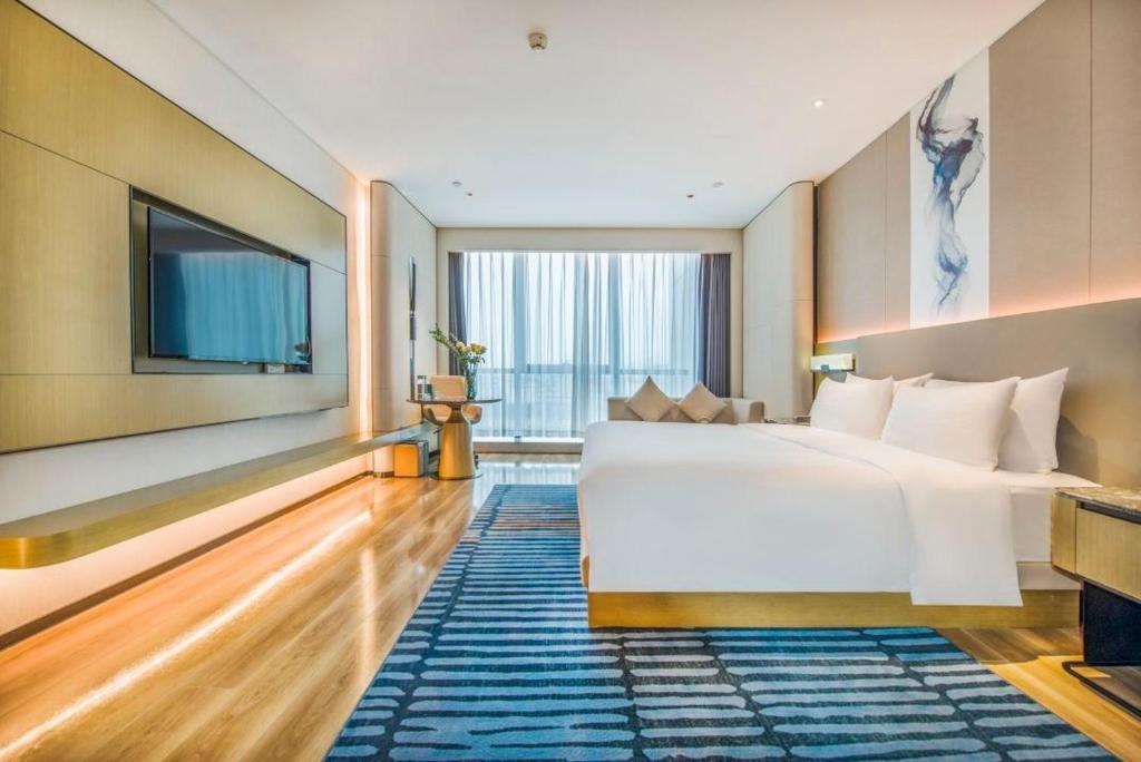 Postel nebo postele na pokoji v ubytování Eastern Casa Hotel Yiwu
