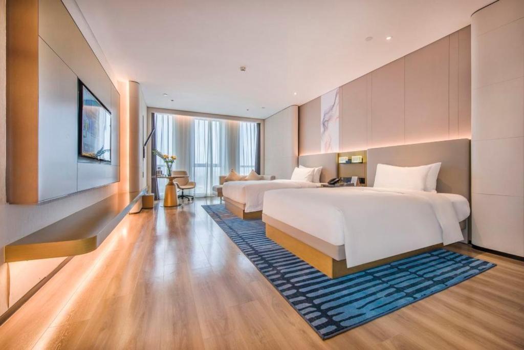 Postel nebo postele na pokoji v ubytování Eastern Casa Hotel Yiwu