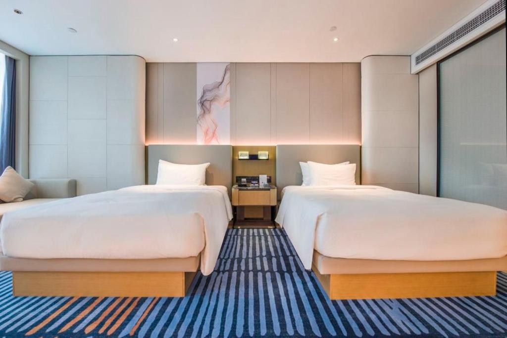 Postel nebo postele na pokoji v ubytování Eastern Casa Hotel Yiwu
