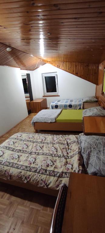 a room with two beds and a table and a tv at Adam room 7 in Wrocław