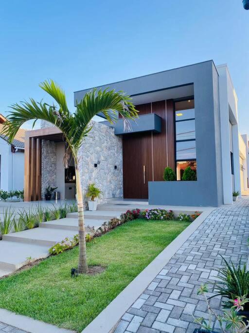 a palm tree in front of a house at LD House- Bananeiras in Bananeiras