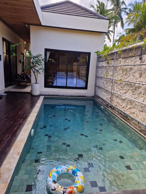 a swimming pool in the backyard of a house at LM Home Mendira in Candidasa