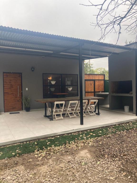 a house with a patio with a table and chairs at Casa finca La catalina I in Maco