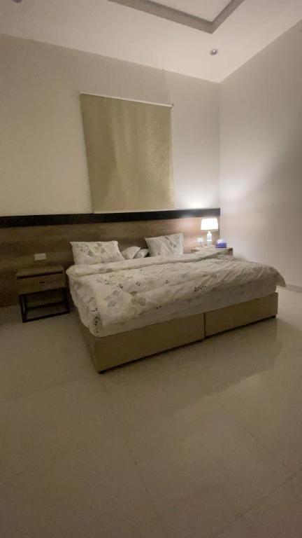a bedroom with a bed in a white room at الدانه 2 in Hafr Al-Batin