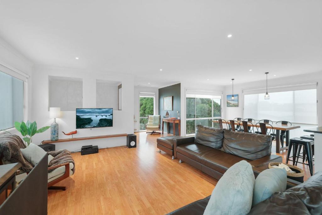 a living room with a couch and a table at Island Surf & Sun in Surf Beach
