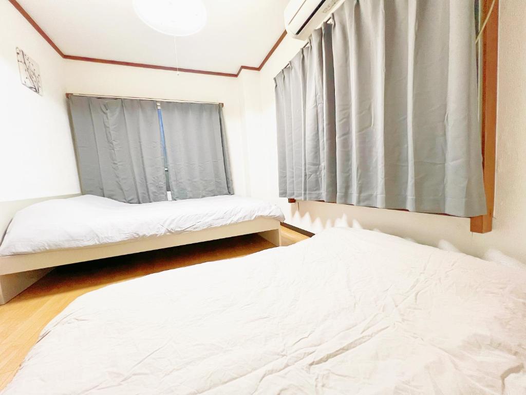 Postel nebo postele na pokoji v ubytování 西武新宿線 駅近最大4人d2
